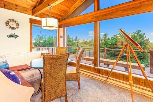 a dining room with a table and chairs and a balcony at Brathouse By The Sea in Copalis Beach