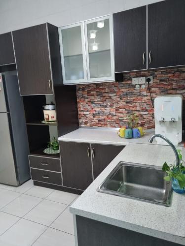 a kitchen with a sink and a brick wall at Ssue Klebang Ipoh Homestay With Complementary Pool & High Speed internet WIFI in Chemor