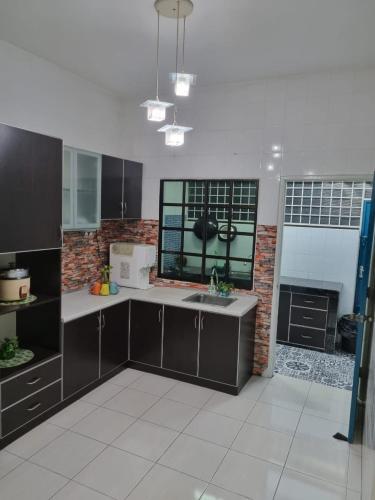 a kitchen with a sink and a brick wall at Ssue Klebang Ipoh Homestay With Complementary Pool & High Speed internet WIFI in Chemor