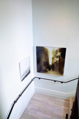 a staircase in a room with a painting on the wall at Gladstone House in Toronto