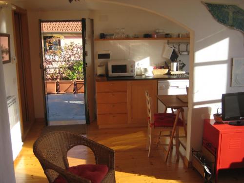 a kitchen with a table and a kitchen with a microwave at Belvedere Lodge in Chiavari
