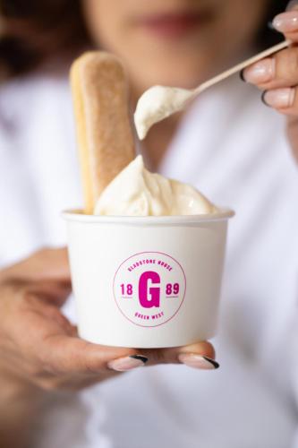 a person holding a cup of ice cream with a banana in it at Gladstone House in Toronto