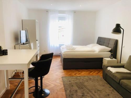 a small living room with a couch and a bed at Fewo Kuferzeile Gmunden seenähe in Gmunden
