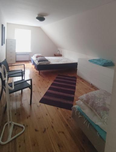 a room with two beds and a desk and a chair at Uuejärve house at Kõrvemaa forest in Pillapalu