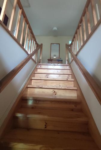a staircase in a house with wooden steps at Uuejärve house at Kõrvemaa forest in Pillapalu