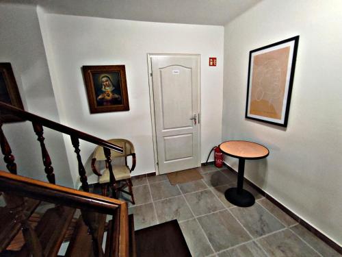 a room with a staircase with a table and a door at Alea Apartmanok in Harkány