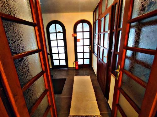 a hallway with two doors and a bench in a room at Alea Apartmanok in Harkány