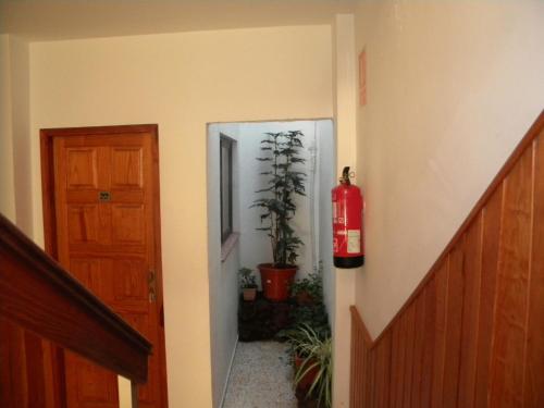 a hallway with a fire extinguisher next to a door at Apartamentos Restinga in La Restinga