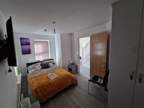 a bedroom with a bed and a wooden floor at 7 Burnby Close,Leeds,LS14 1GA in Leeds