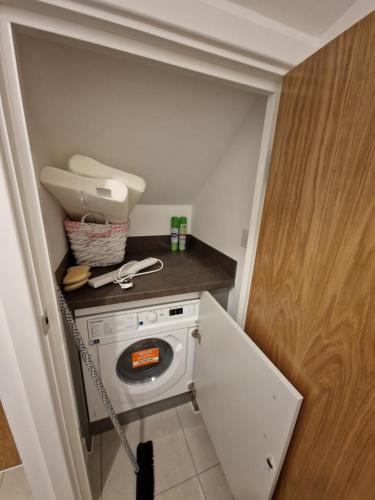 a small laundry room with a washer and dryer at 7 Burnby Close,Leeds,LS14 1GA in Leeds