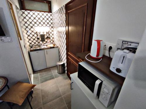 a small kitchen with a toaster on a counter at Alea Apartmanok in Harkány