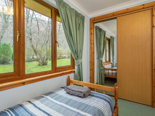 a bedroom with a bed and a window at Bidean Lodge in Glencoe