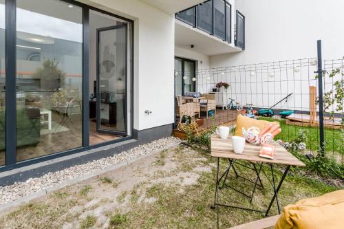 a patio with a table in front of a house at Enjoy! Ursus in Warsaw