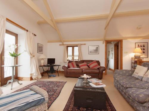 a living room with a couch and a table at Shadycombe Lodge in Salcombe