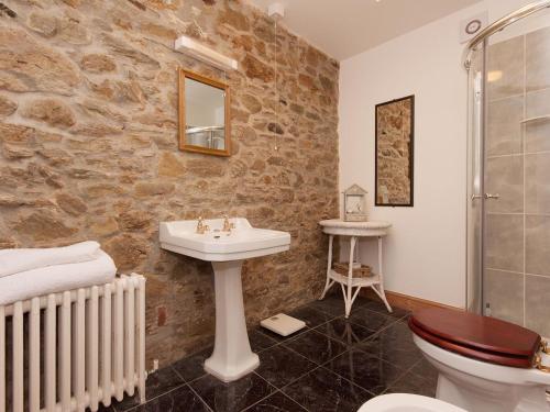 a bathroom with a sink and a toilet and a shower at Shadycombe Lodge in Salcombe