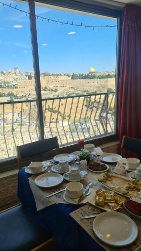 a table with a view of the desert from a window at Jerusalem Panorama Hotel in Jerusalem