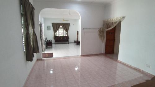 a living room with a tile floor and a hallway at Seri Dusun Sepang Homestay & Event Space in Sepang