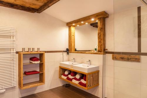 a bathroom with a sink and a mirror at Berghütte Ahornblick in Hippach
