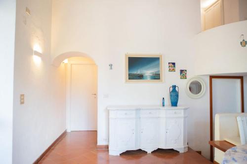 a white room with a white counter and a door at Villa in Anacapri