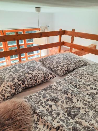 a bedroom with a bed with a wooden head board at Velký apartmán Cihlarka in Cerny Dul