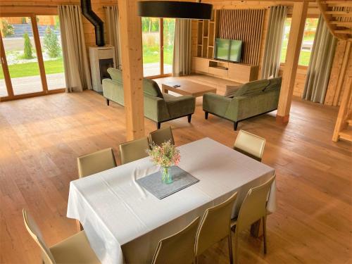 une salle à manger avec une table et des chaises blanches dans l'établissement Chata Green, à Veľká Lomnica