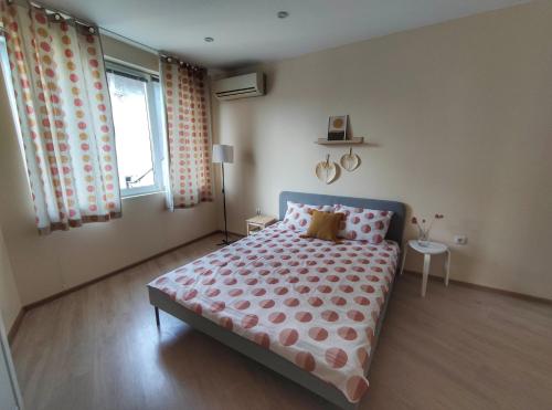 a bedroom with a bed and a window at By The Cathedral, 1 bed flat in Varna City