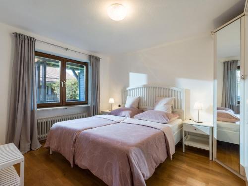 a bedroom with a large bed and a window at Ferienwohnung Panoramablick in Oberaudorf