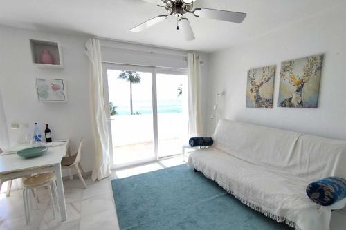a living room with a white couch and a window at Avenida España 154 - AE11 in Estepona