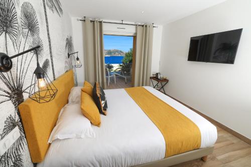 a bedroom with a bed with a view of the ocean at Le Saint Erasme, Hotel Eco Friendly in Calvi
