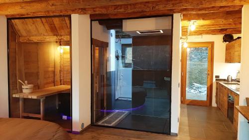 a room with a glass door leading to a kitchen at Chalet Cormignano in Vezza dʼOglio