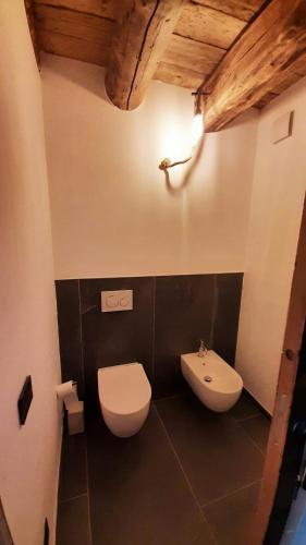 a bathroom with a toilet and a sink at Chalet Cormignano in Vezza dʼOglio