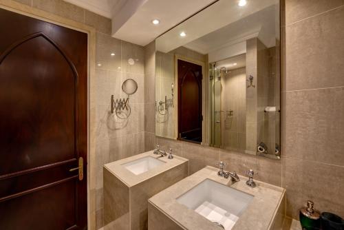 a bathroom with two sinks and a large mirror at Durrani Homes - Heaven on Earth in Dubai