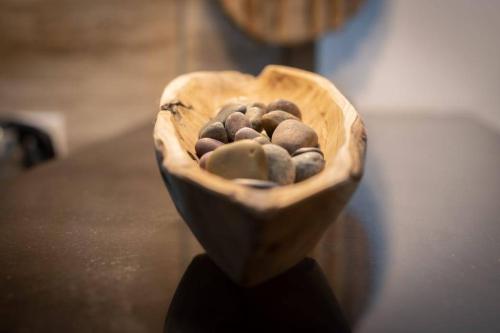 a wooden bowl filled with rocks on a table at Treasure Villa in Anse Possession