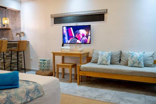 a living room with a couch and a table at Treasure Villa in Anse Possession