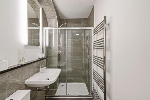 a bathroom with a glass shower and a sink at Lux Georgian House in Yorkshire - Parking - Garden in Wakefield