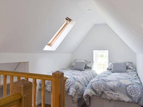 1 dormitorio con 2 camas en un ático en Stars Cottage en Moreton