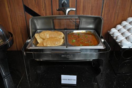 a plate of food on top of a stove at Hotel Tip Top International Pune in Pune