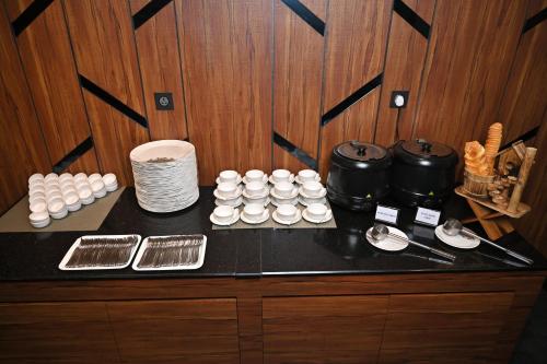 a counter top with a bunch of food on it at Hotel Tip Top International Pune in Pune