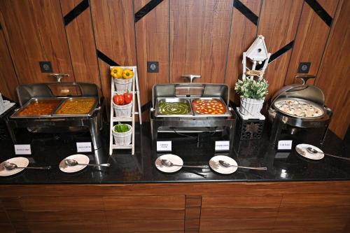 a counter with some food on top at Hotel Tip Top International Pune in Pune