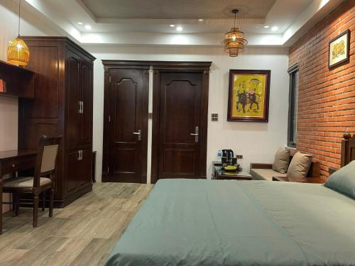 a bedroom with a bed and a desk and a couch at Eco nest in Hanoi