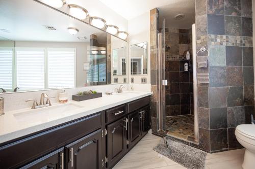 a bathroom with a shower and a sink and a toilet at Luxury Home Near Las Vegas Strip and Airport. in Las Vegas
