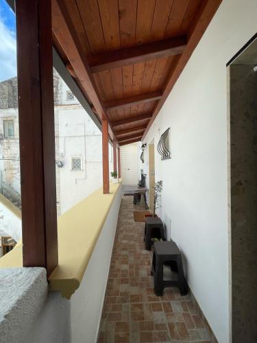 an empty hallway of a building with a wooden ceiling at B&B Le Volte 27 in Gravina in Puglia