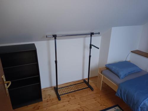 a small room with a bed and a small bed and a bed at Eva apartman in Slavonski Brod