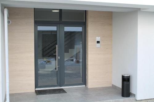 a glass door on the side of a building at VISAJ Homes in Timişoara