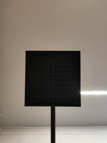 a black lamp in front of a white wall at Dream Nest Meteora in Kalabaka