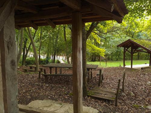 a group of picnic tables and benches in a park at Brvnara u planini in Petrovac na Mlavi