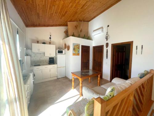 a living room with a couch and a table at Casa De Los Baños in Cazalla de la Sierra