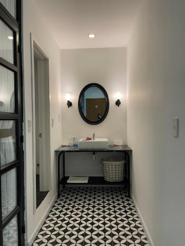 a bathroom with a sink and a mirror at Nomad Apartment in Nha Trang