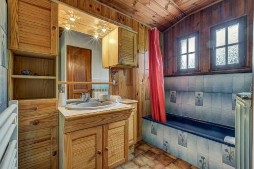 La salle de bains est pourvue d'un lavabo et d'une baignoire. dans l'établissement CHALET Trois Bois - Alpes Travel - LES HOUCHES - sleeps 8, aux Houches