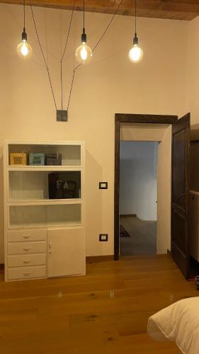 a bedroom with a bed and a dresser and lights at La casa di mezzo in Calascio
